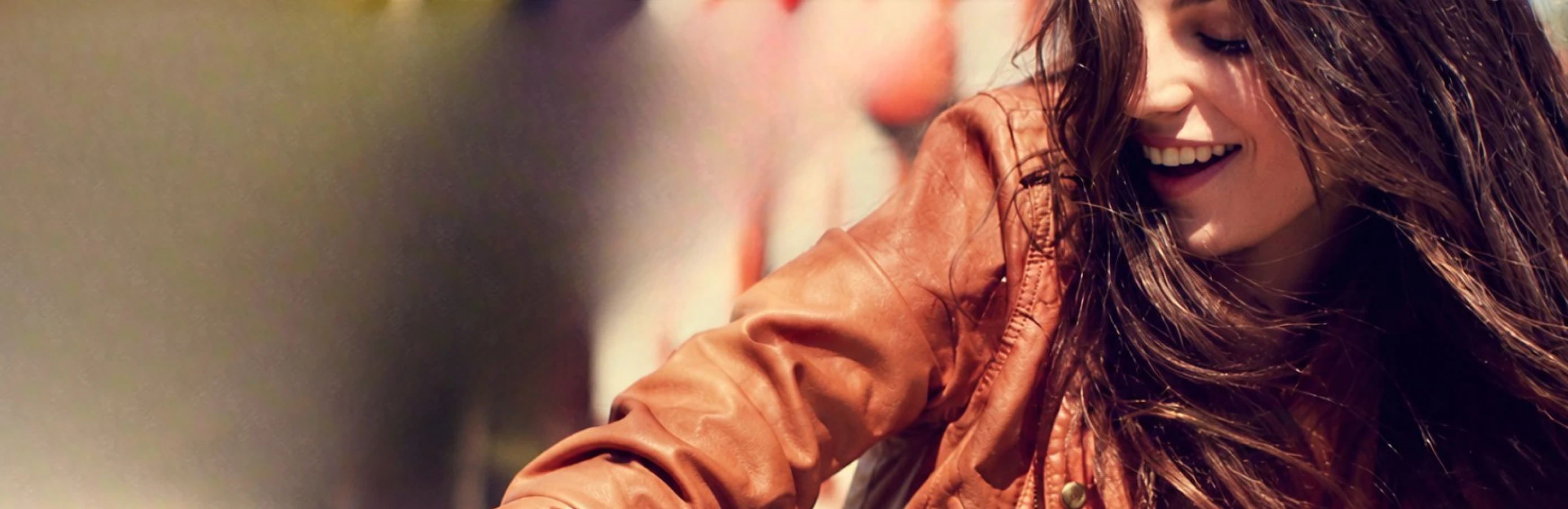 A woman wearing an orange jacket, representing Volkswagen Group digital applications