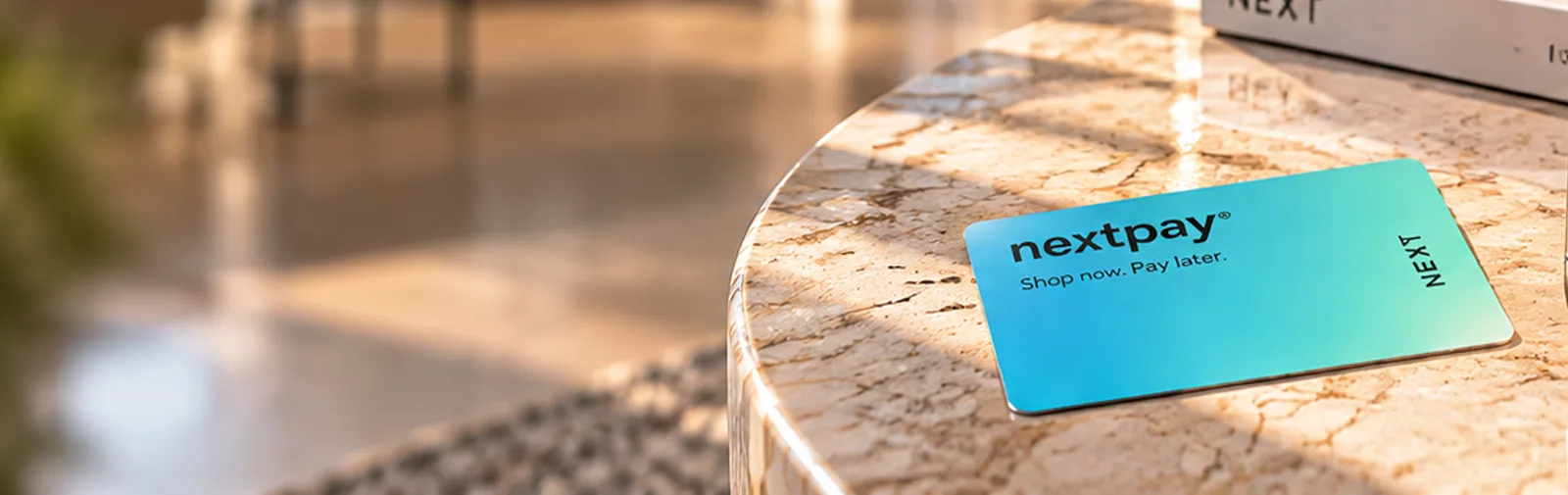 NextPay credit card on a marble table